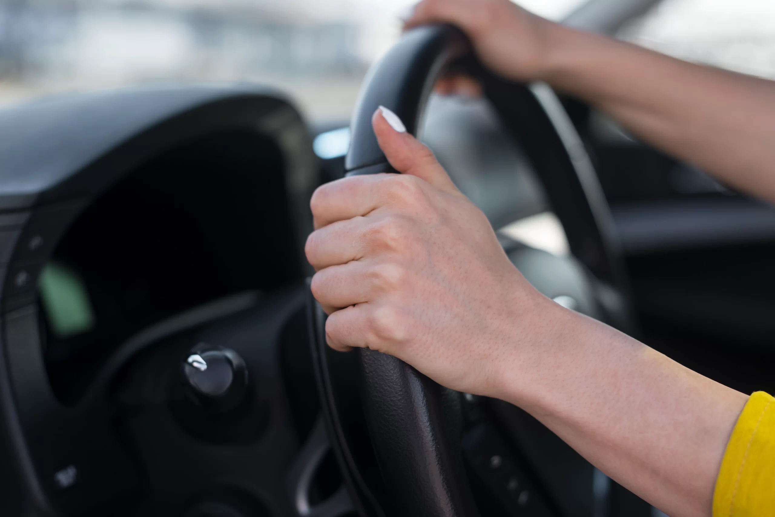 1-woman-hands-holding-steering-wheel