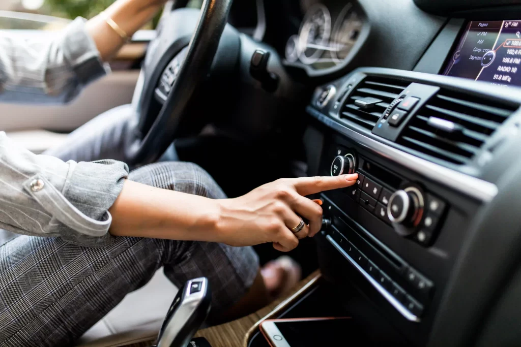 1-car-dashboard-radio-closeup-woman-sets-up-radio-while-driving-car