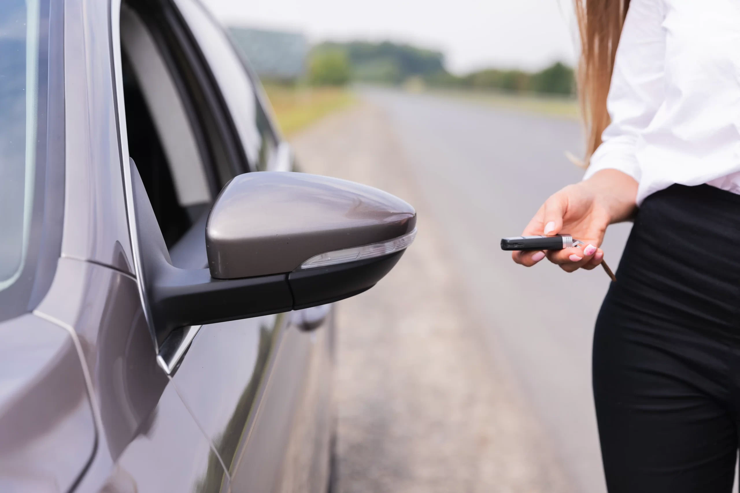 1-woman-locks-car-side-road