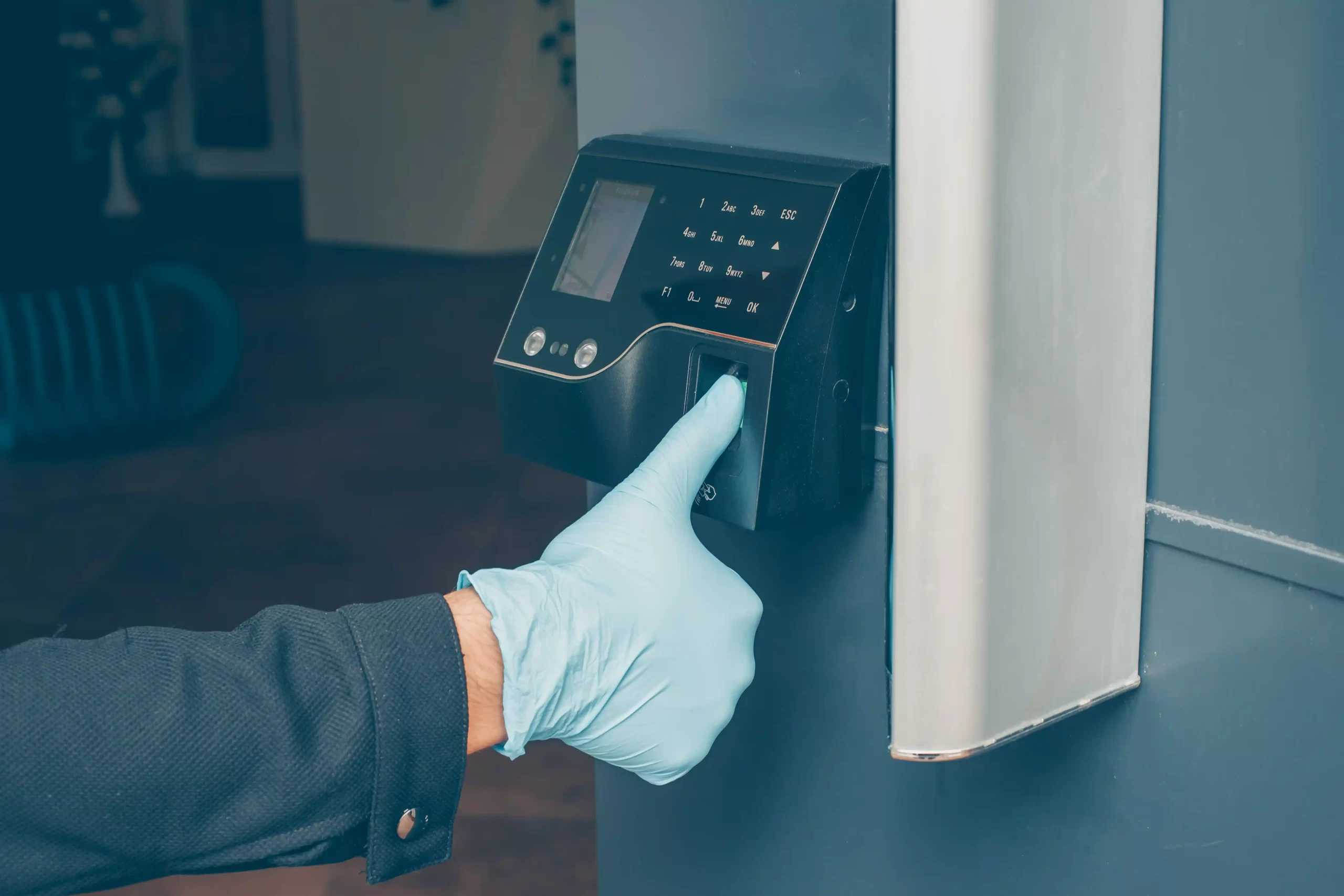 man-getting-intercom-read-his-fingerprint-open-door-with-gloves